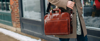 Close up of a Single gusset stringer bag being worn by a man walking down the sidewalk in winter.