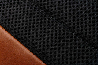 Black mesh over tan leather texture.