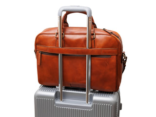 Bosca Stringer Bag on suitcase.